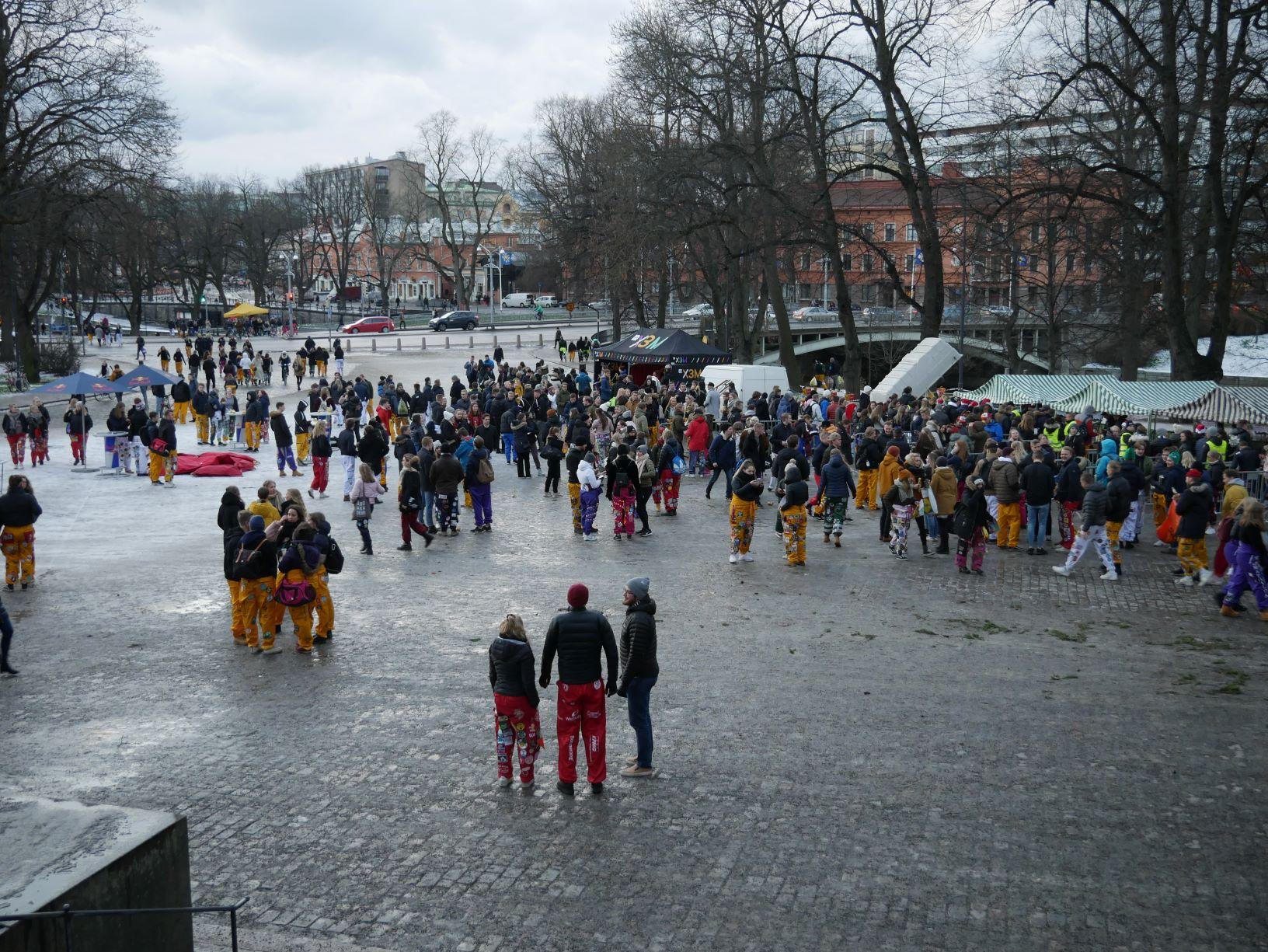 Domkyrkotorget i Åbo fyllt med personer klädda i halare i olika färger. Vädret är grått.