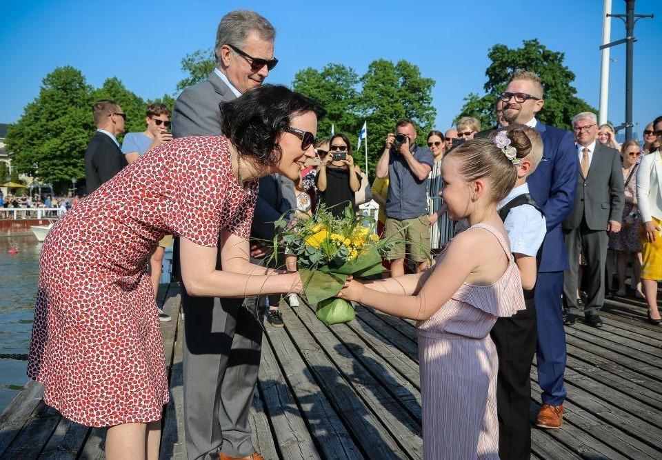 Presidentparet får blommor av två skolelever