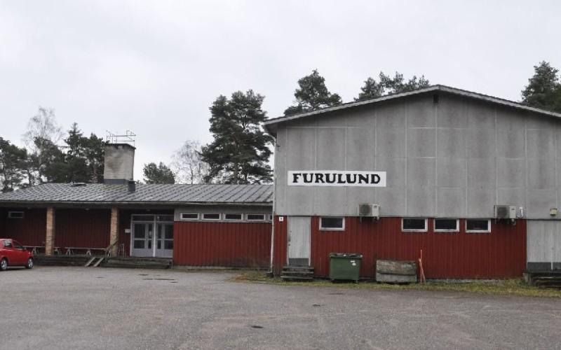 Stort föreningshus i grått ocg vitt, med skylten "Furulund"