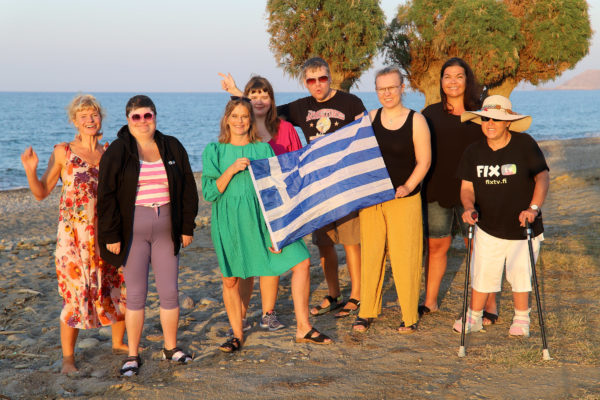 Människor i solen med grekisk flagga
