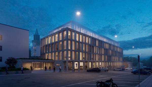 visionsbild av ny universitetsbyggnad i kvällsbelysning