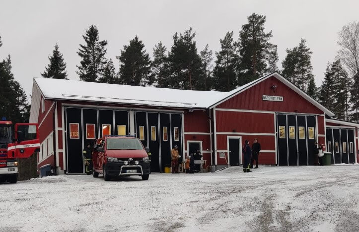 Brandbilar utanför brandstation på vintern.